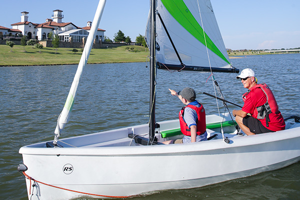 Grandfather and grandson sailing on Lake Viridian