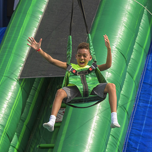 Child jumping at Viridian events in the DFW area. 
