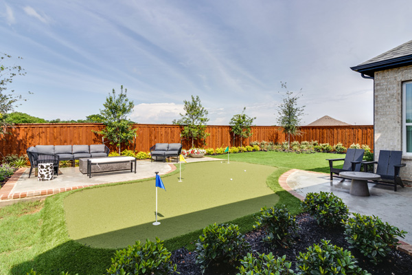 Spacious backyard with room for grandkids to play and a putting green