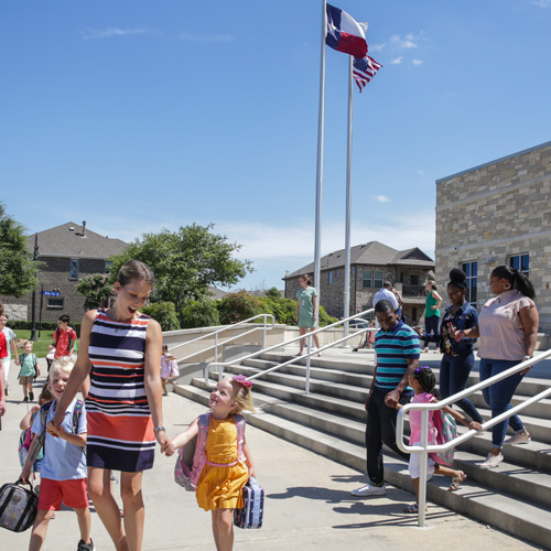 Mother and child leave Viridian Elementary for nearby new homes.