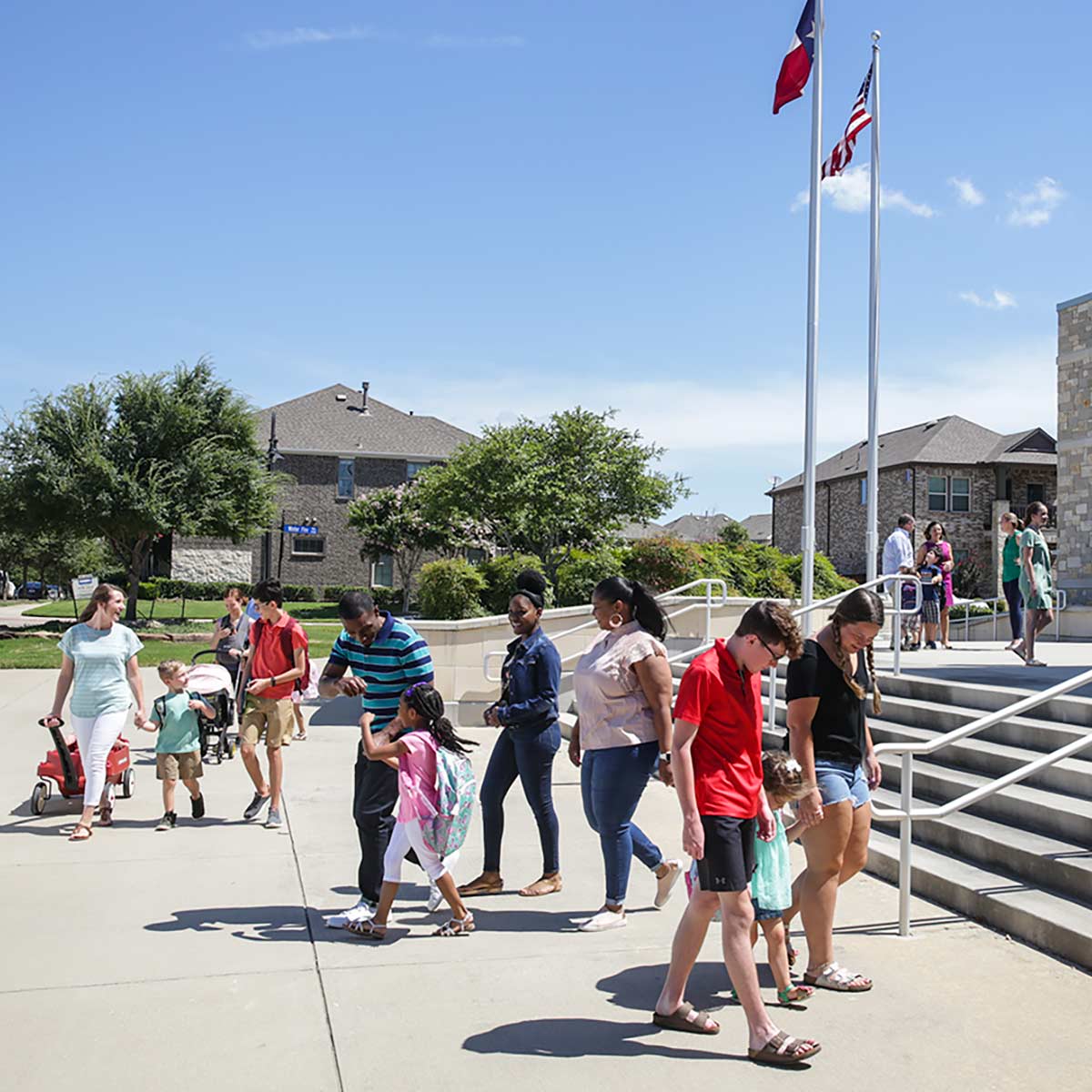 Parents and guardians happily walk their children into Viridian Elementary. 